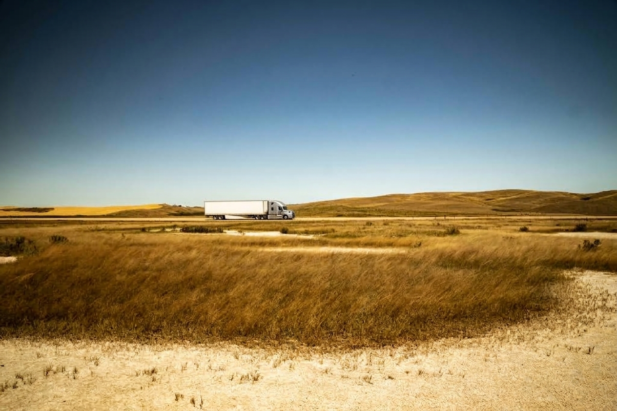 Freight truck travelling across open prairie